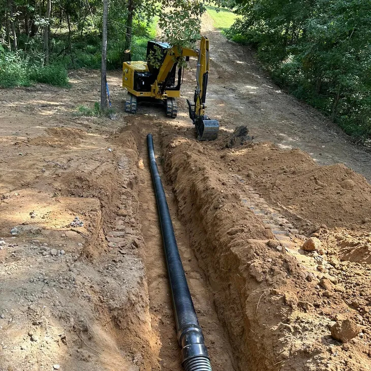Excavator ditch digging for land development in Memphis